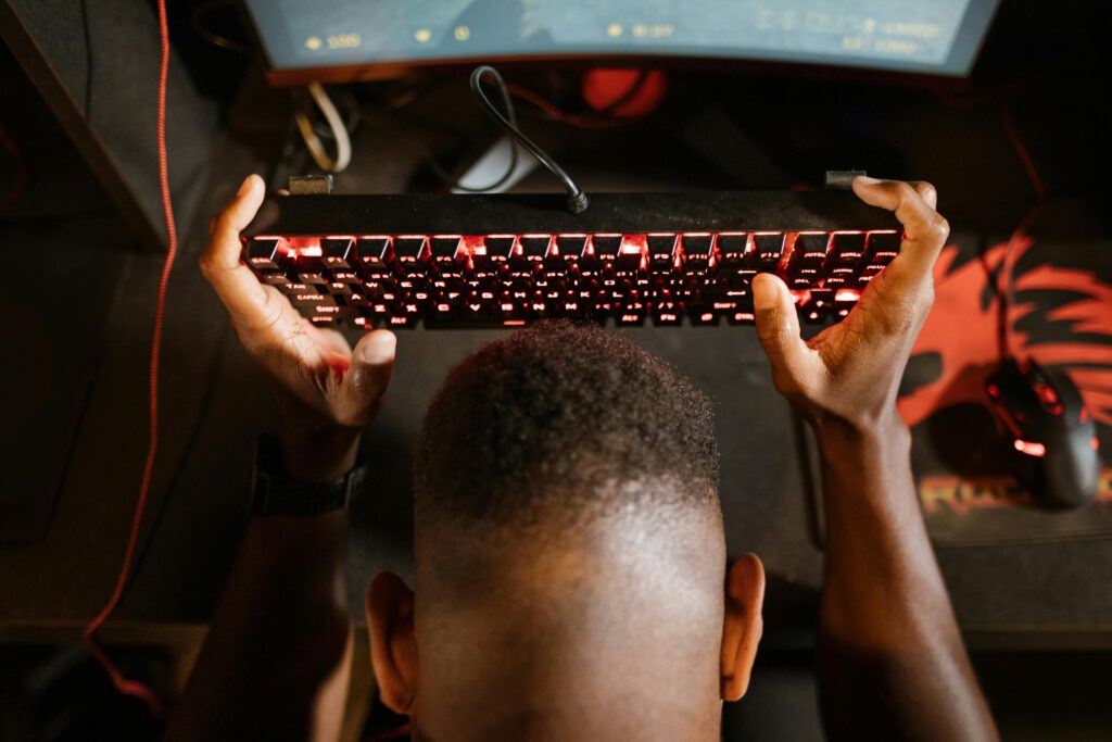 Overhead Shot of a Man Holding His Mechanical Keyboard